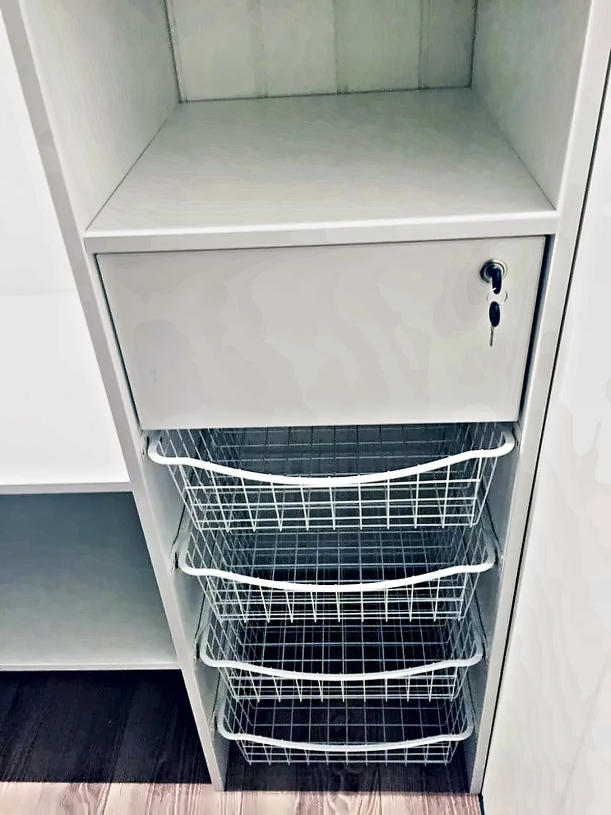 Seksjon med trådkurver og låsbar skuff